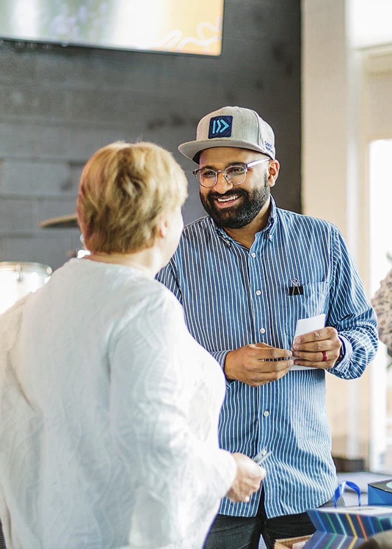 Pranay Borde talking with a church member at Hillcrest Community Church